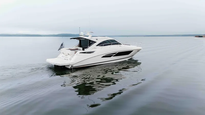 Slide: The Image of 2013 Sea Ray 510 Sundancer yacht cruising on calm waters. - 19