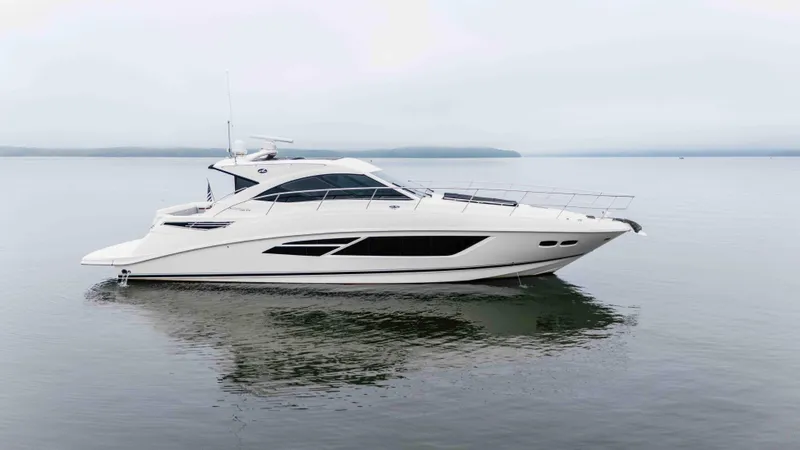 Slide: The Image of 2013 Sea Ray 510 Sundancer yacht on calm water, side view. - 2