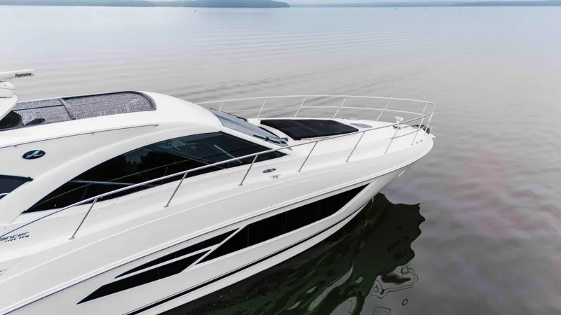 Slide: The Image of 2013 Sea Ray 510 Sundancer yacht on calm water, showcasing sleek design and luxury features. - 20