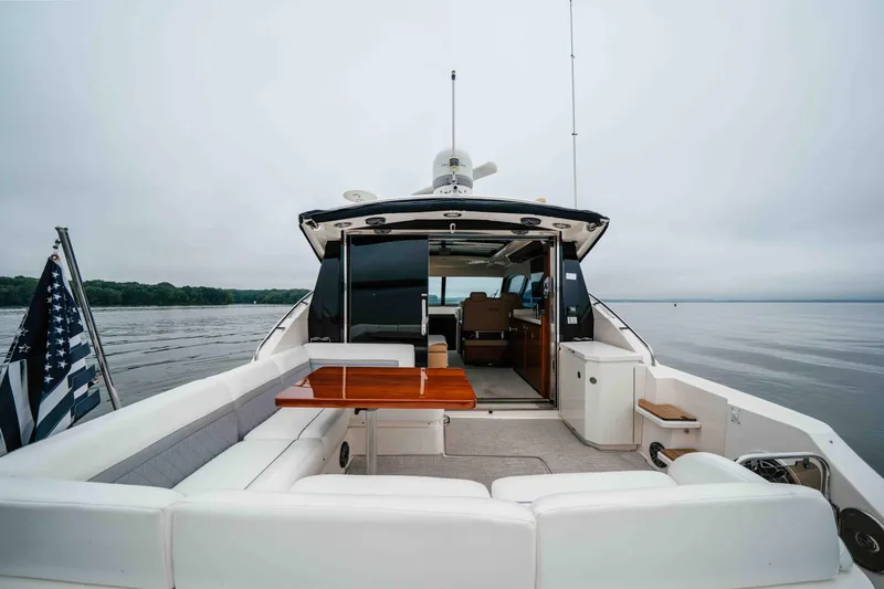 Slide: The Image of 2013 Sea Ray 510 Sundancer yacht with spacious deck and elegant seating on calm waters. - 21
