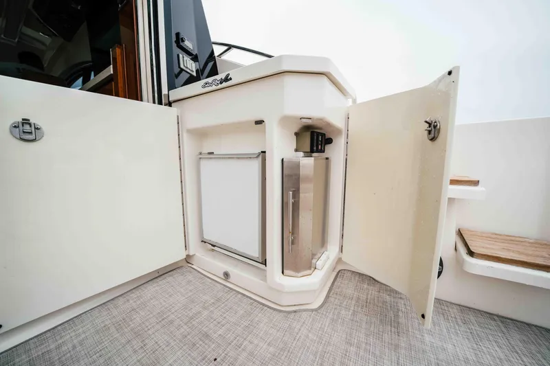 Slide: The Image of 2013 Sea Ray 510 Sundancer yacht interior with open storage compartments. - 27