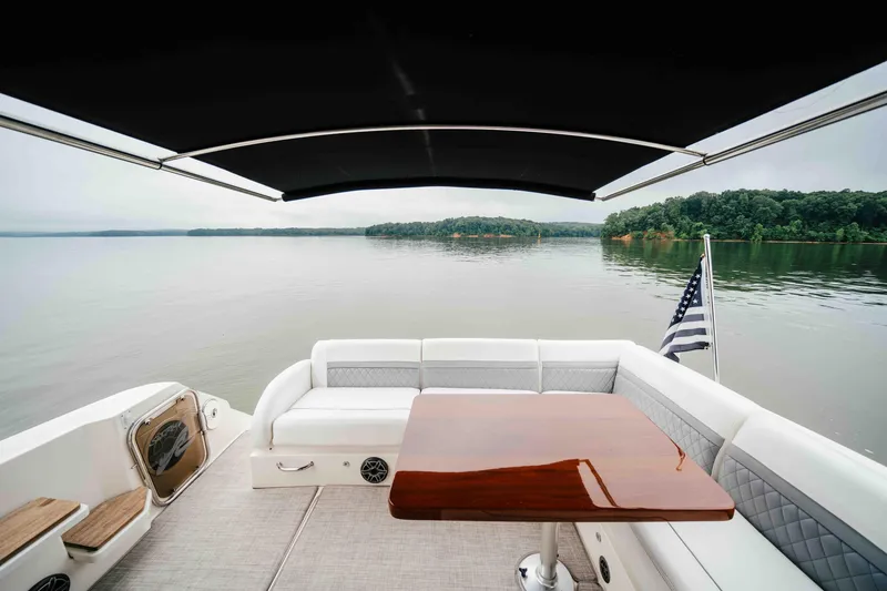 Slide: The Image of Luxurious 2013 Sea Ray 510 Sundancer yacht with elegant seating and scenic lake view. - 29