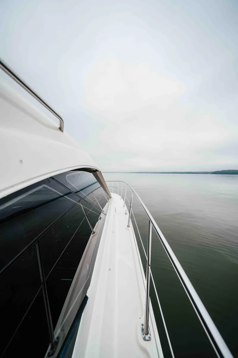 Slide: The Image of 2013 Sea Ray 510 Sundancer yacht cruising on calm waters under a cloudy sky. - 33