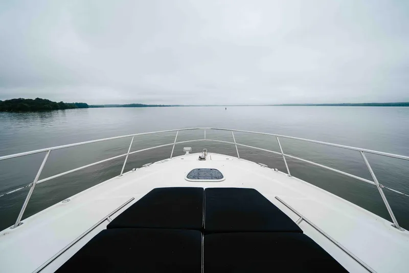 Slide: The Image of Bow view of 2013 Sea Ray 510 Sundancer on calm waters under cloudy sky. - 35
