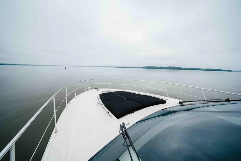Slide: The Image of 2013 Sea Ray 510 Sundancer yacht cruising on calm waters under a cloudy sky. - 39