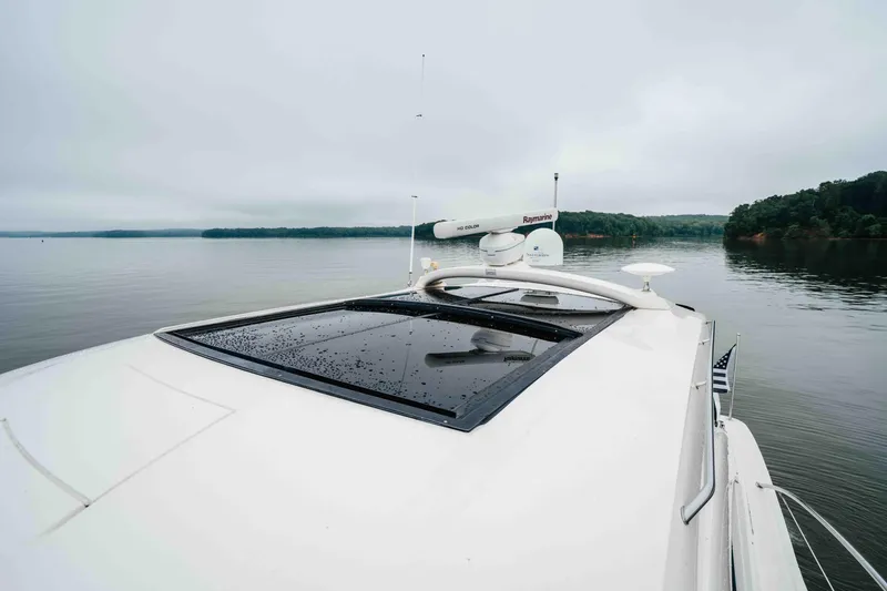 Slide: The Image of 2013 Sea Ray 510 Sundancer yacht on calm water, featuring sleek design and advanced navigation equipment. - 40