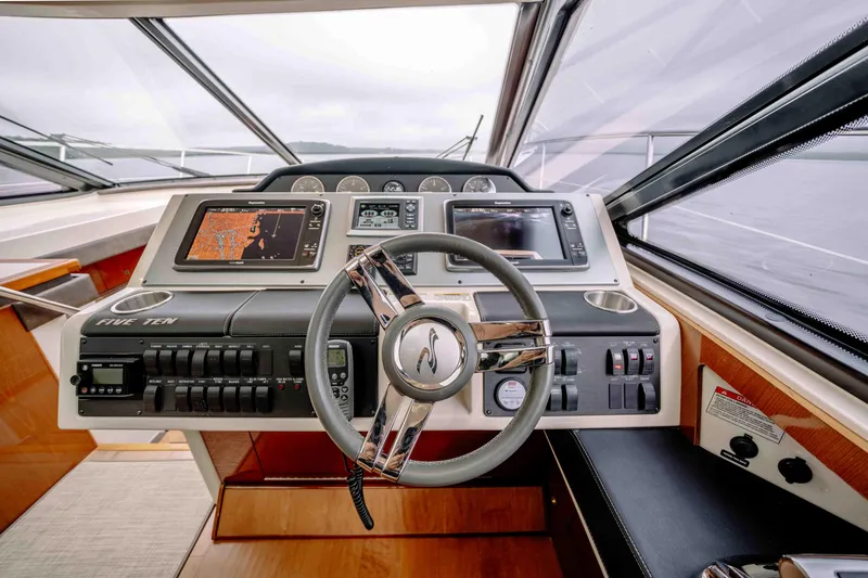 Slide: The Image of 2013 Sea Ray 510 Sundancer helm with advanced navigation systems and sleek design. - 45