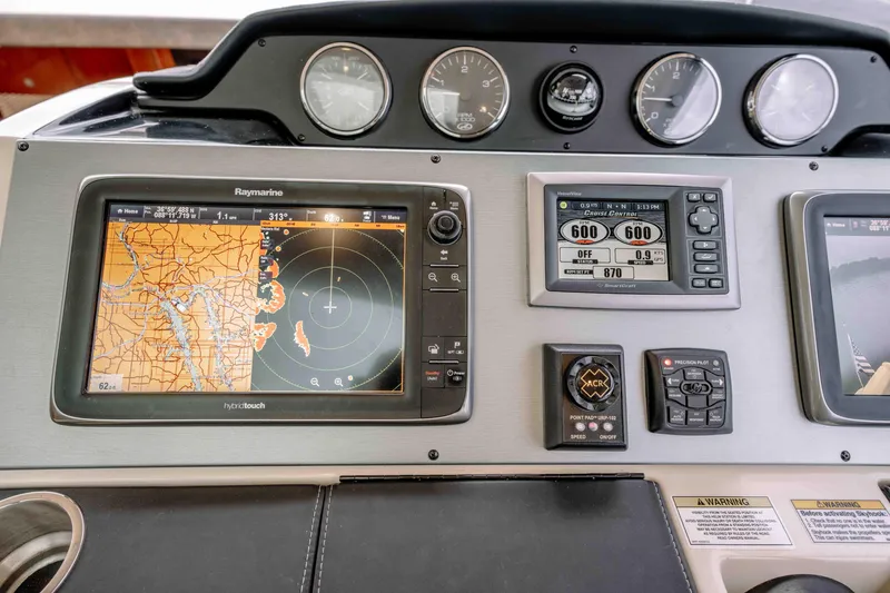 Slide: The Image of Control panel of a 2013 Sea Ray 510 Sundancer with navigation and monitoring systems. - 48