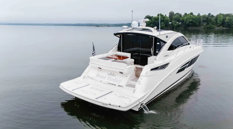 Slide: The Image of 2013 Sea Ray 510 Sundancer yacht on calm water, rear view. - 6