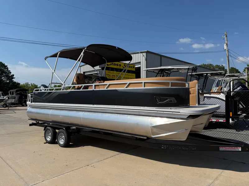 The Image of 2025 Avalon Venture 85 Versatile Rear Bench pontoon boat on trailer, outdoor display. - 0