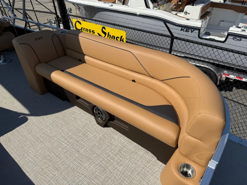 Slide: The Image of Luxurious tan seating on 2025 Avalon Venture 85 Versatile rear bench, featuring cup holder and speaker. - 13