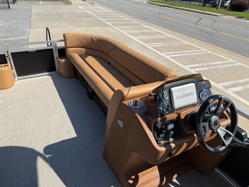 Slide: The Image of 2025 Avalon Venture 85 Versatile rear Bench with Garmin navigation, featuring luxurious tan seating. - 25