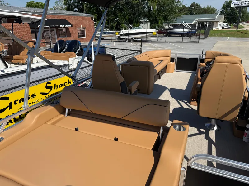 Slide: The Image of 2025 Avalon Venture 85 Versatile rear Bench boat with tan seating, displayed at a dealership. - 35