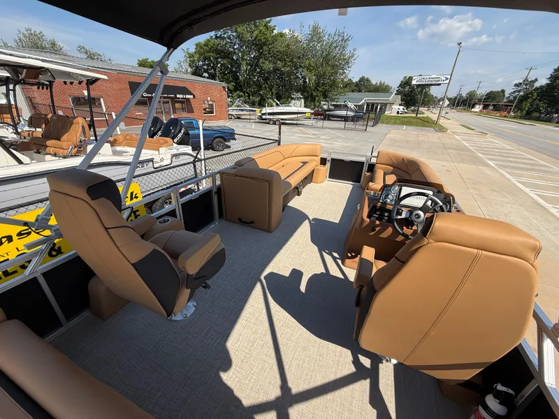 Slide: The Image of 2025 Avalon Venture 85 Versatile pontoon boat with tan seating and modern helm. - 38