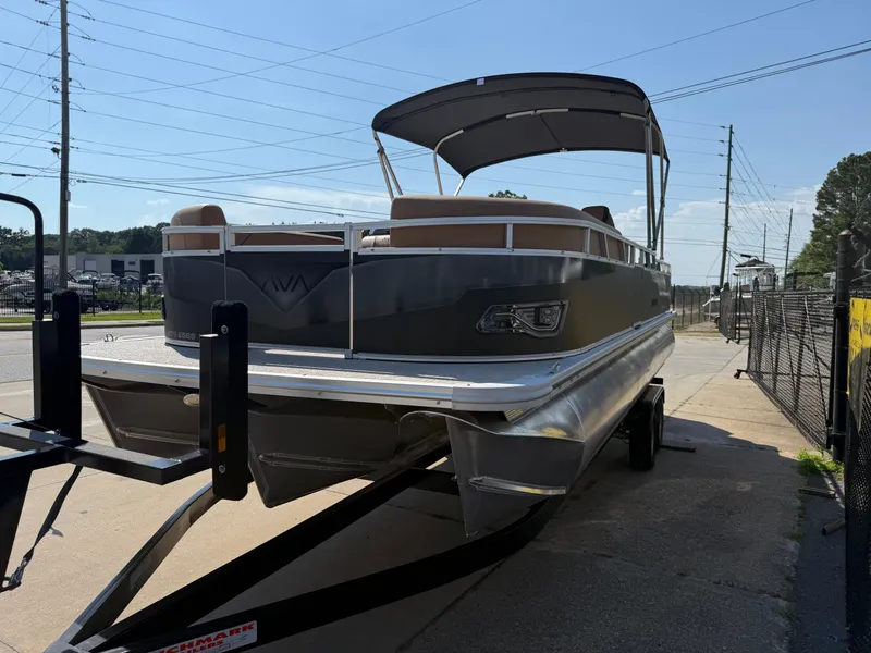 Slide: The Image of 2025 Avalon Venture 85 Versatile Rear Bench pontoon boat on trailer, parked outdoors. - 4