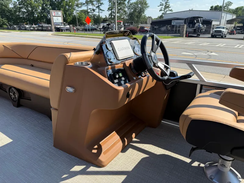 Slide: The Image of 2025 Avalon Venture 85 Versatile rear bench with Garmin navigation, brown interior, and steering wheel. - 41