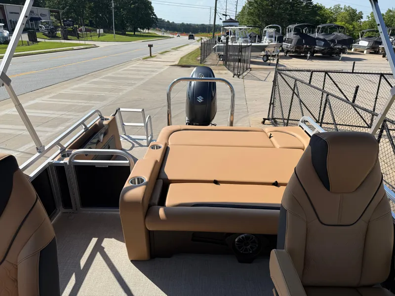 Slide: The Image of 2025 Avalon Venture 85 Versatile rear bench boat with tan seating, parked near a road. - 46