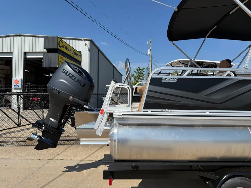 Slide: The Image of 2025 Avalon Venture 85 Versatile pontoon boat with Suzuki outboard motor at dealership. - 7