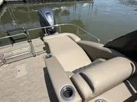 Slide: The Image of 2022 Bennington 30 RSRAX2 boat with beige seating, docked by the water. - 16
