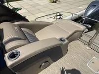 Slide: The Image of 2022 Bennington 30 RSRAX2 boat with beige seating and cup holders. - 17