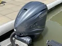 Slide: The Image of Yamaha outboard motor on a 2022 Bennington 30 RSRAX2 boat docked by water. - 18
