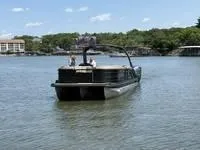 Slide: The Image of 2022 Bennington 30 RSRAX2 pontoon boat on a lake with scenic background. - 2