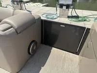 Slide: The Image of 2022 Bennington 30 RSRAX2 boat interior with seating and storage compartment. - 22