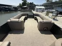 Slide: The Image of 2022 Bennington 30 RSRAX2 pontoon boat with spacious seating at a marina. - 23