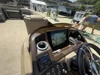 Slide: The Image of 2022 Bennington 30 RSRAX2 boat dashboard with navigation screen and controls. - 24