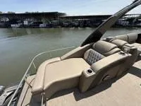 Slide: The Image of 2022 Bennington 30 RSRAX2 luxury boat with plush seating, docked by the water. - 26