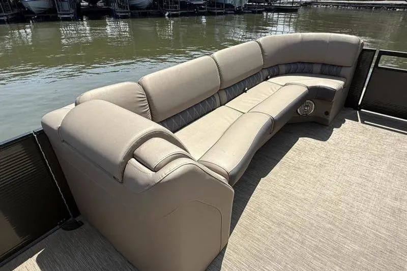 Slide: The Image of 2022 Bennington 30 RSRAX2 pontoon boat with luxurious beige seating by the water. - 31