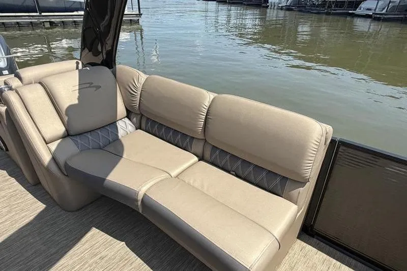 Slide: The Image of Luxurious seating on 2022 Bennington 30 RSRAX2 pontoon boat by the water. - 32