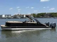 Slide: The Image of 2022 Bennington 30 RSRAX2 pontoon boat on calm water, with scenic background. - 4