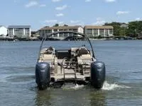 Slide: The Image of 2022 Bennington 30 RSRAX2 pontoon boat on water, with buildings in the background. - 7