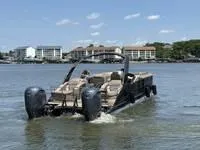 Slide: The Image of 2022 Bennington 30 RSRAX2 pontoon boat on water, with buildings in the background. - 8