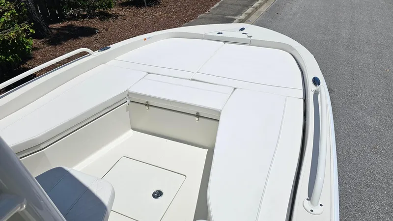 Slide: The Image of 2025 Ranger 2360 Bay boat interior with white seating and storage compartments. - 10