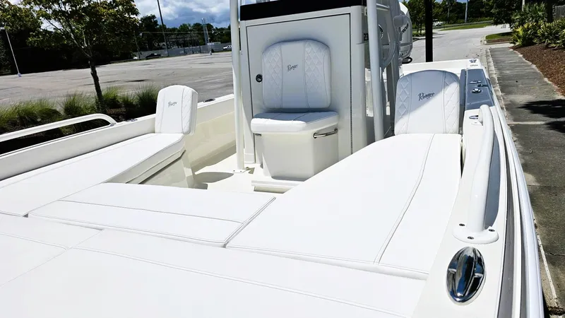 Slide: The Image of 2025 Ranger 2360 Bay boat with white seating and sleek design. - 16