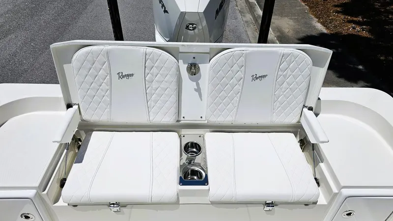 Slide: The Image of 2025 Ranger 2360 Bay boat with white quilted seating and cup holders. - 20