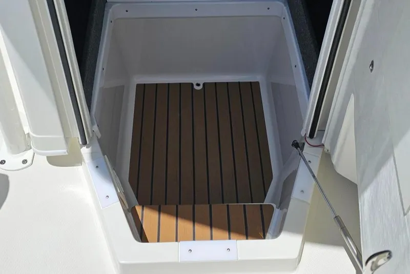 Slide: The Image of 2025 Ranger 2360 Bay boat storage compartment with wood-like flooring. - 21
