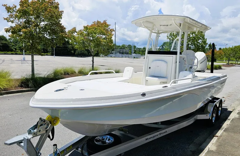 Slide: The Image of 2025 Ranger 2360 Bay boat on trailer in parking lot, sunny day. - 9
