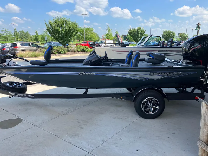 The Image of 2025 Ranger RT188P fishing boat on trailer, parked outdoors under blue sky. - 0