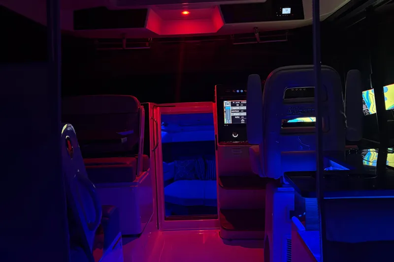 Slide: The Image of 2025 Boston Whaler 365 Conquest interior with ambient red and blue lighting. - 36