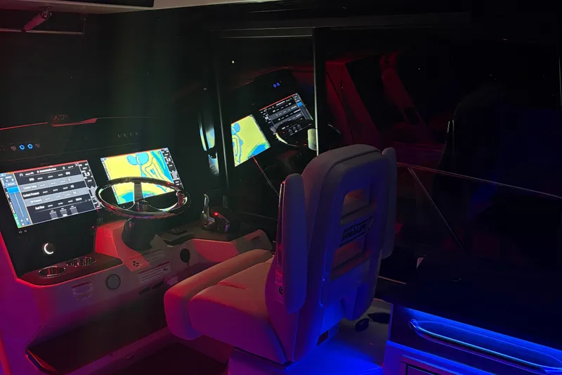 Slide: The Image of 2025 Boston Whaler 365 Conquest helm with illuminated navigation screens and controls. - 38