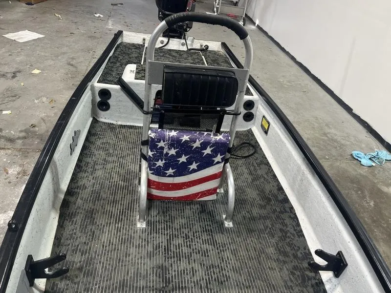 Slide: The Image of 2022 Gheenoe Low Tide 25 boat interior with American flag-themed seat. - 6