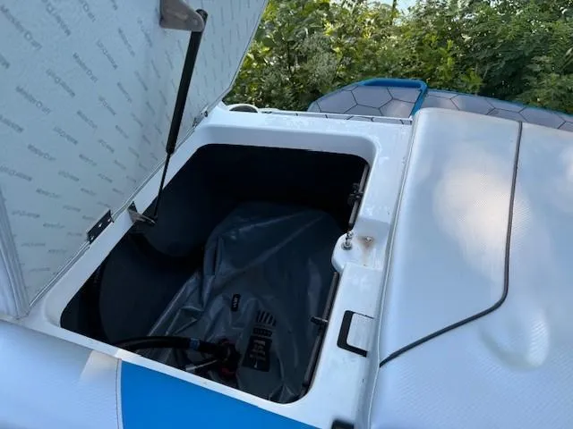 Slide: The Image of 2017 MasterCraft NXT22 boat storage compartment open, showing interior details. - 14