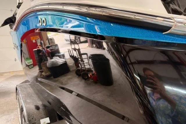 Slide: The Image of 2017 MasterCraft NXT22 boat in garage, reflecting surroundings, showcasing sleek design. - 35