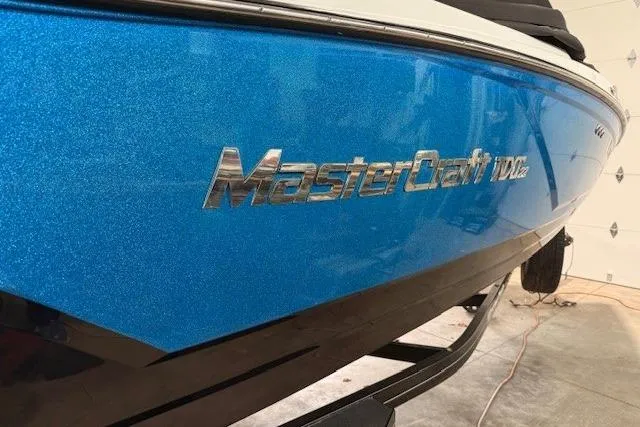 Slide: The Image of 2017 MasterCraft NXT22 boat with blue metallic finish in a garage setting. - 36