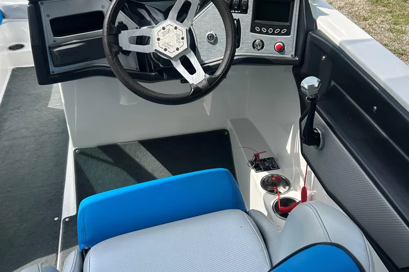 Slide: The Image of 2017 MasterCraft NXT22 boat interior with steering wheel and control panel. - 39