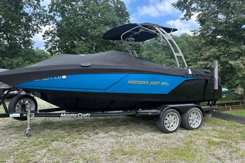 Slide: The Image of 2017 MasterCraft NXT22 boat on trailer, covered, parked outdoors. - 43