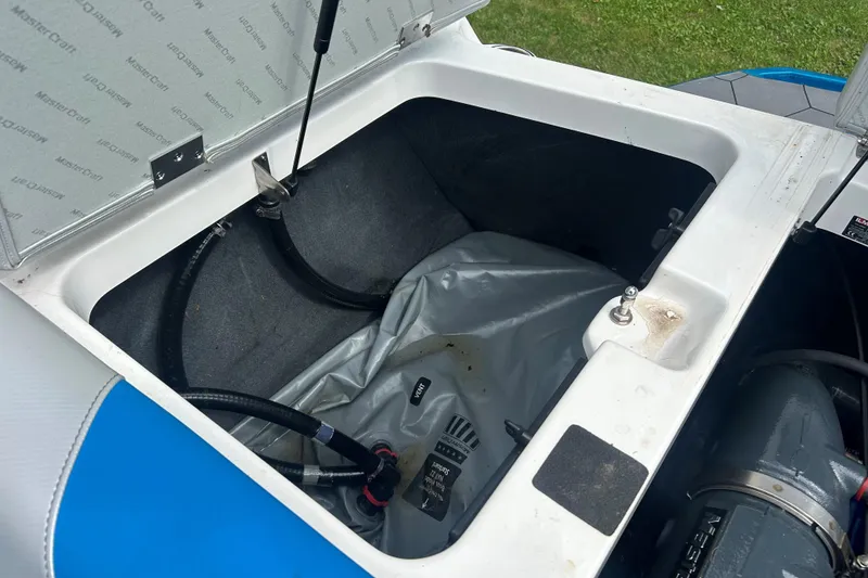 Slide: The Image of Open storage compartment in 2017 MasterCraft NXT22 boat, showing interior details and components. - 49